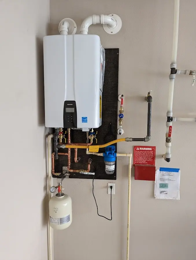 Professional plumber installing copper piping in a Branchburg home